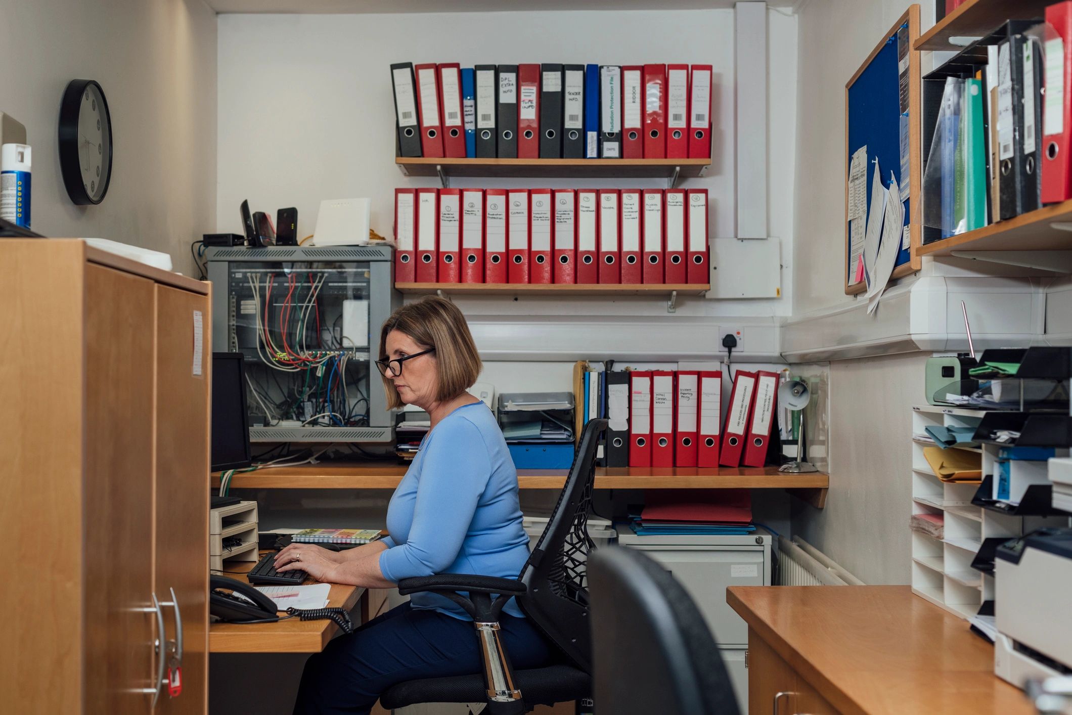 Cybersecurity analyst working at a computer in a modern office