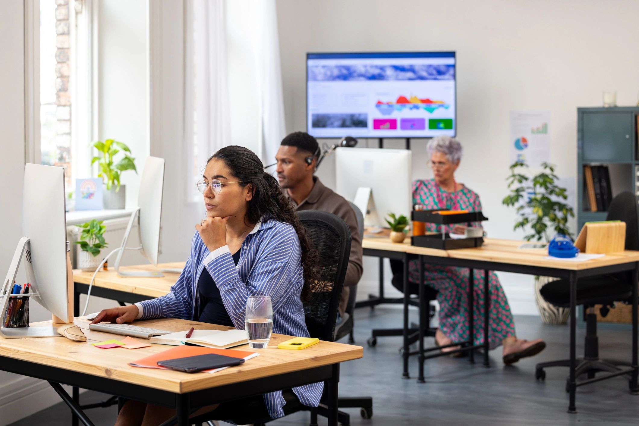 Security operations team monitoring threat dashboards in a modern office